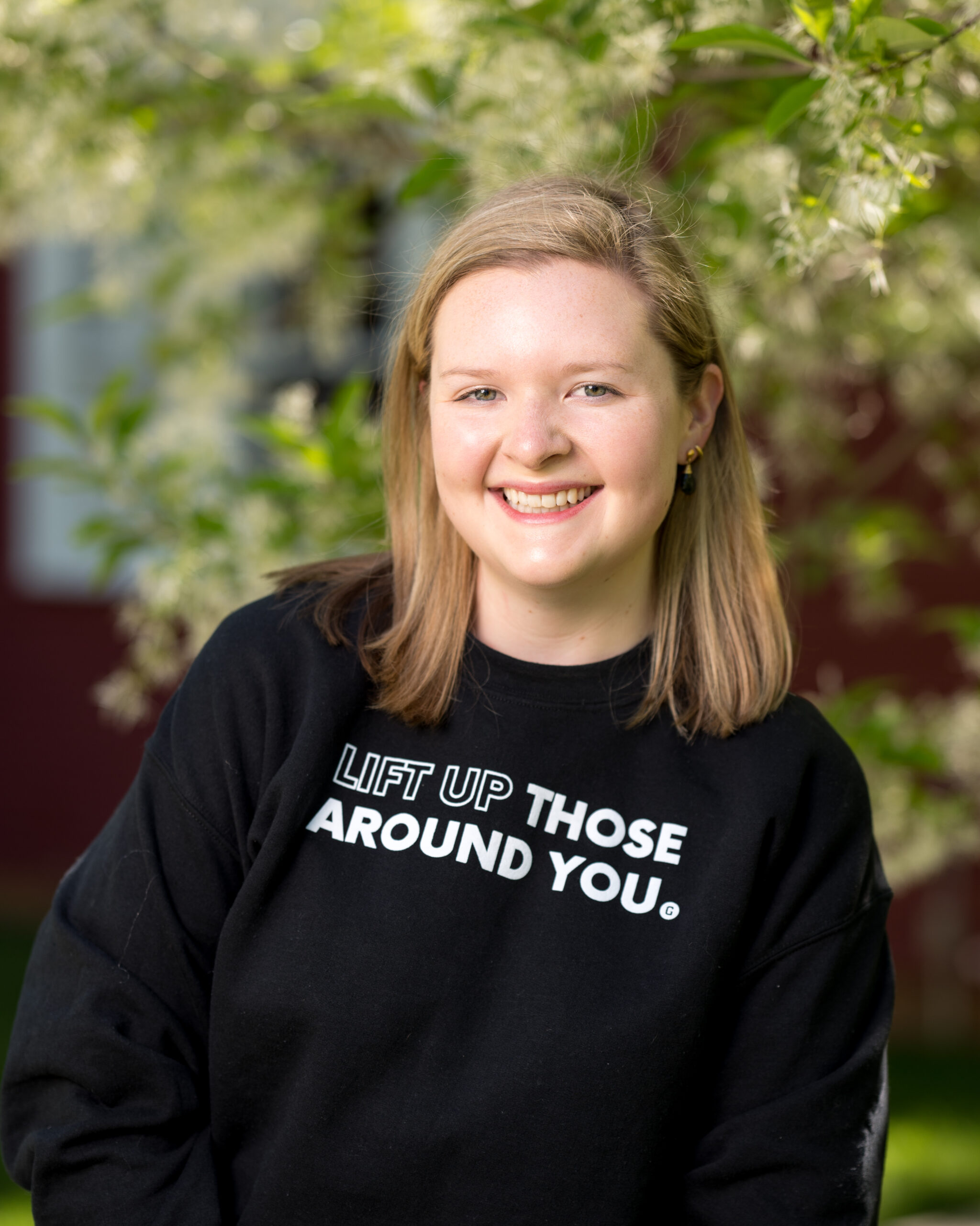 GiveCampus employee wearing a values sweatshirt that says,