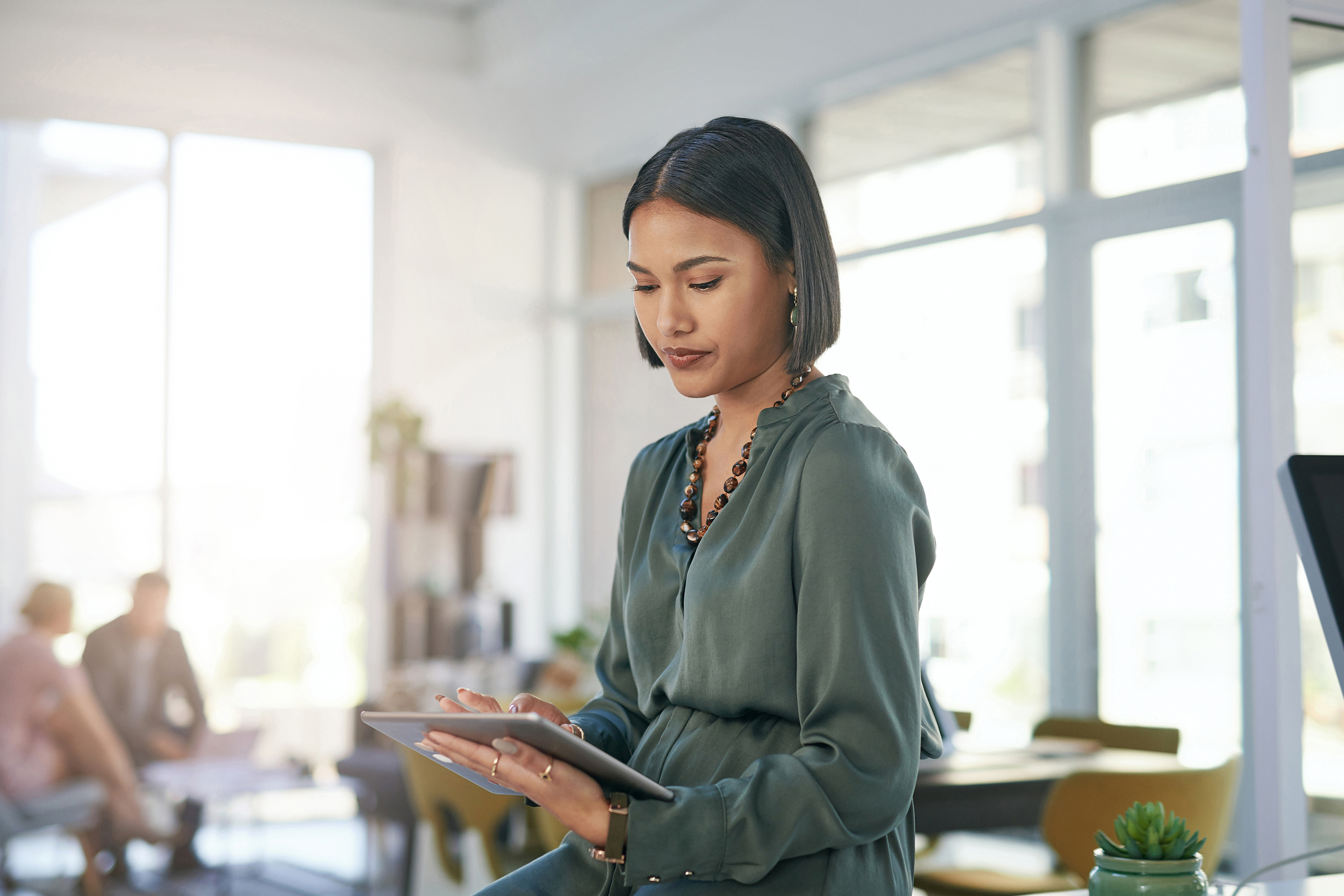 A woman accessing a tablet