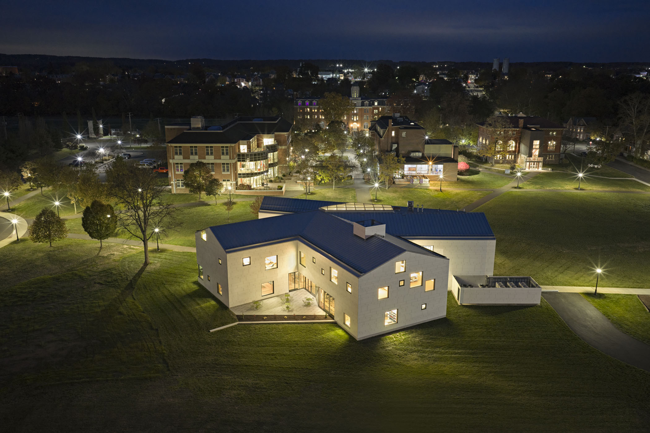 An evening aerial view of Perkiomen School’s campus featuring the Breidegam Student Center in the foreground.