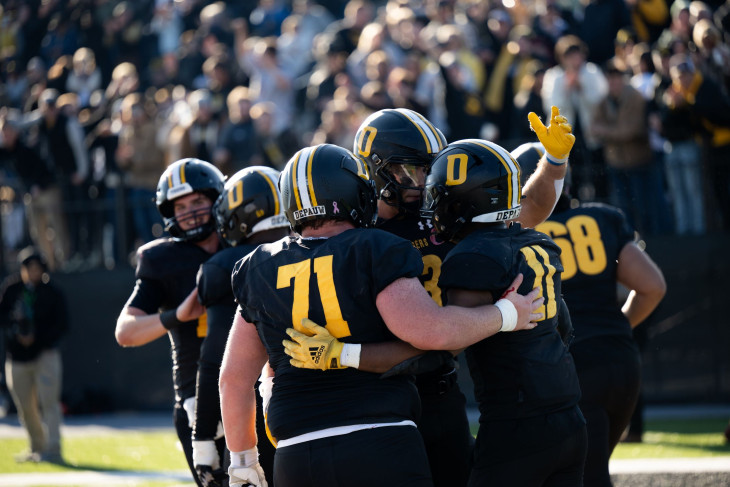 DePauw Tigers celebrate on field during 2024 Monon Bell matchup.